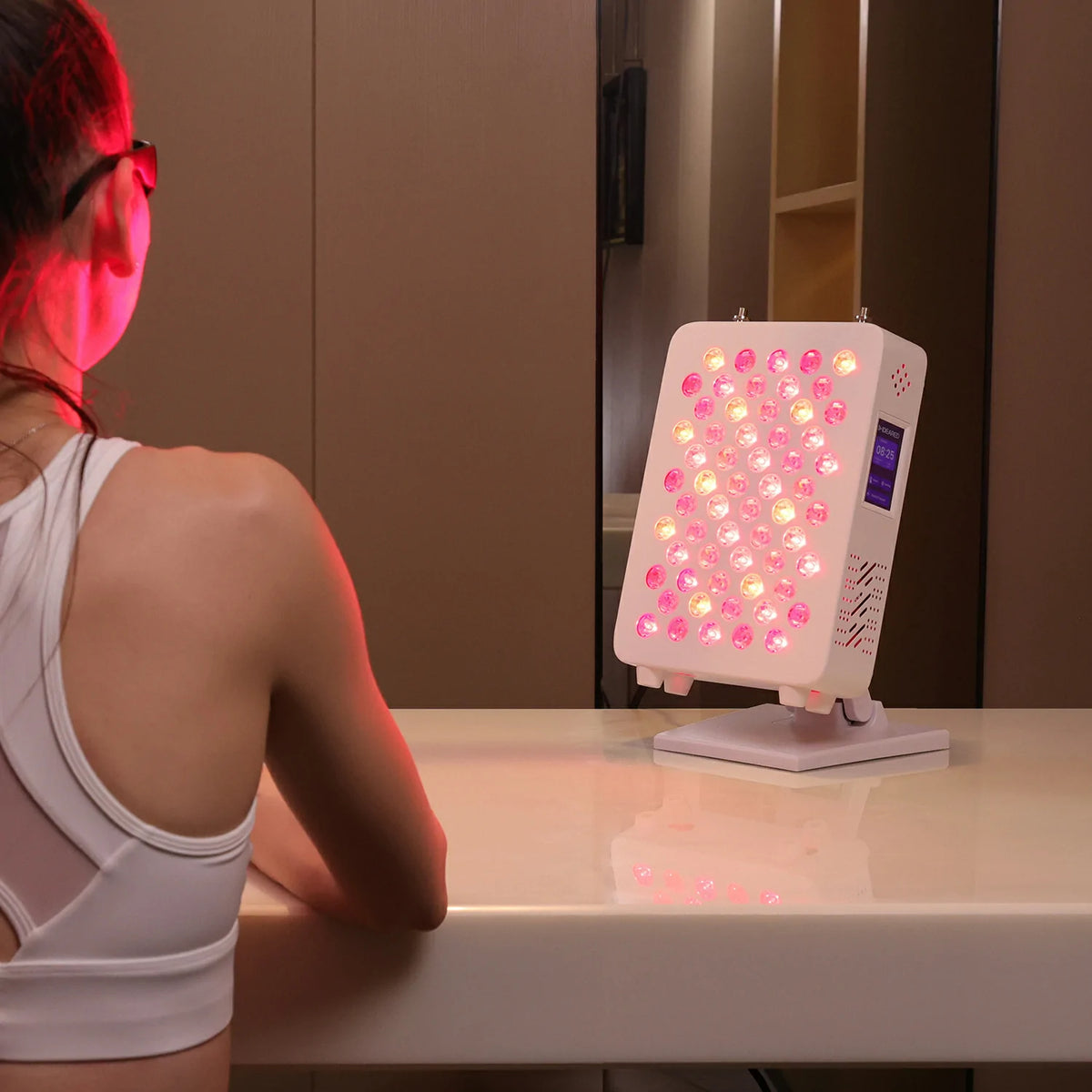 Person using the RL60S desktop red light therapy panel