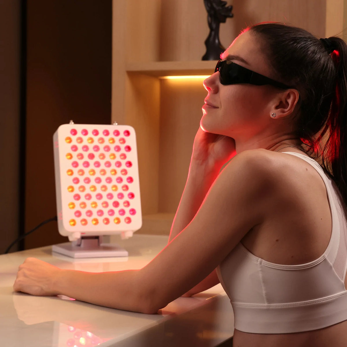 Person using the RLPRO100-X2 portable red light therapy panel