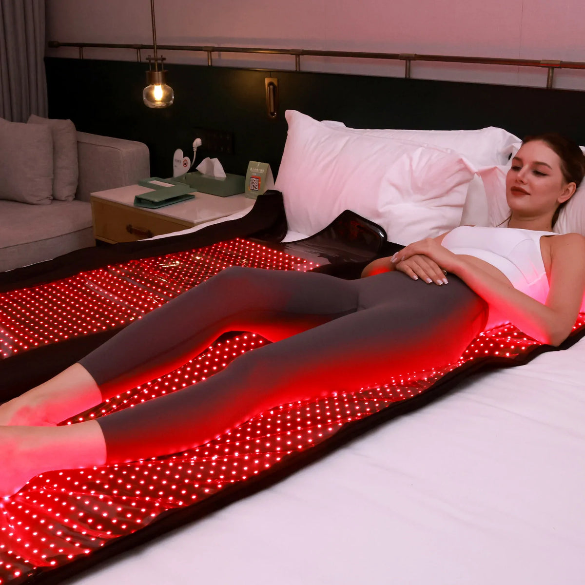 Person using the TLB2000-K red light therapy sleeping bag