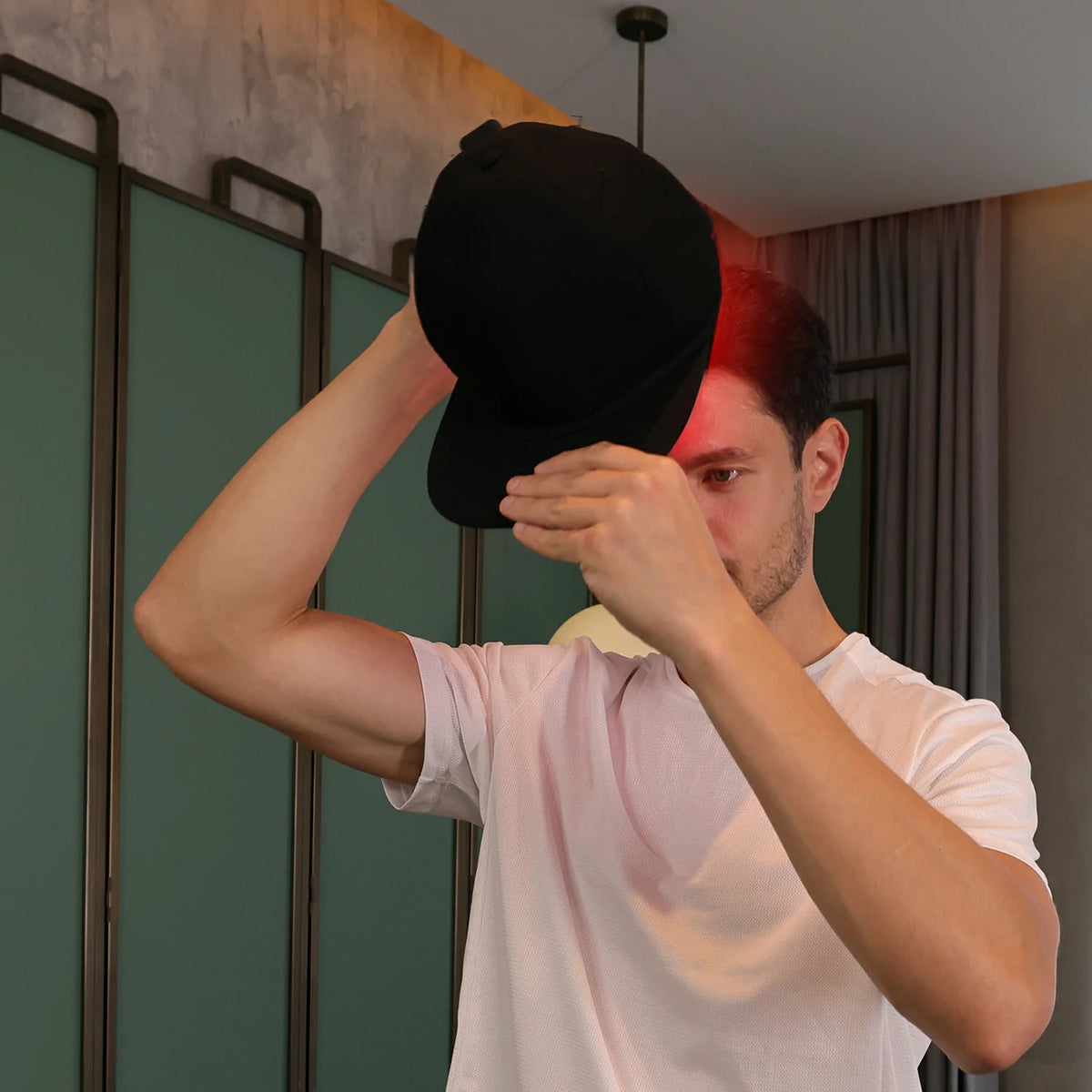 Person using the TLH150WP-A red light therapy cap