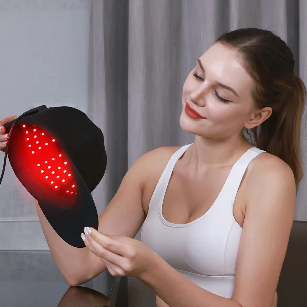 Person using the TLH150WP red light therapy cap