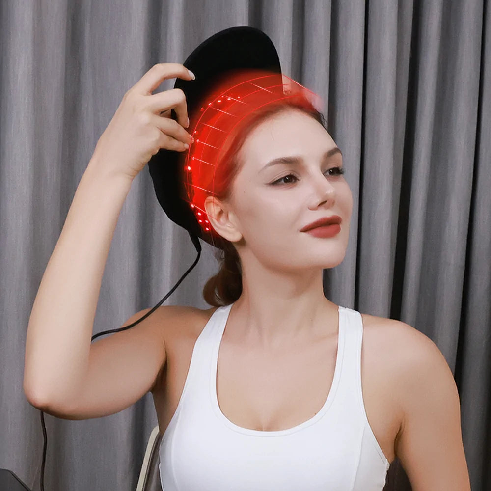 Person using the TLH150WP red light therapy cap